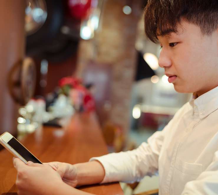 young person using a phone to search for ways to get support for their mental health during the holidays